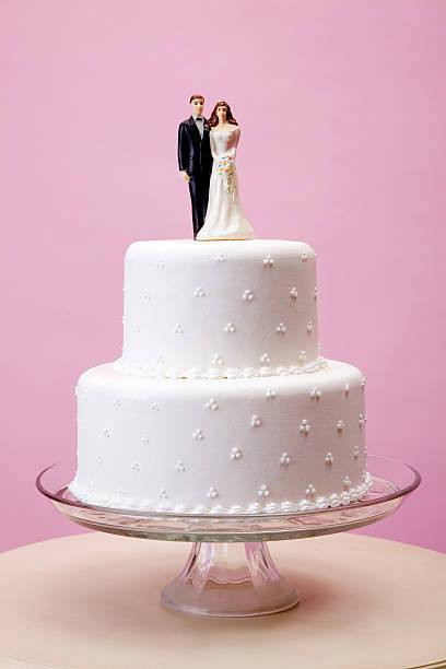 Wedding cake with bride and groom topper